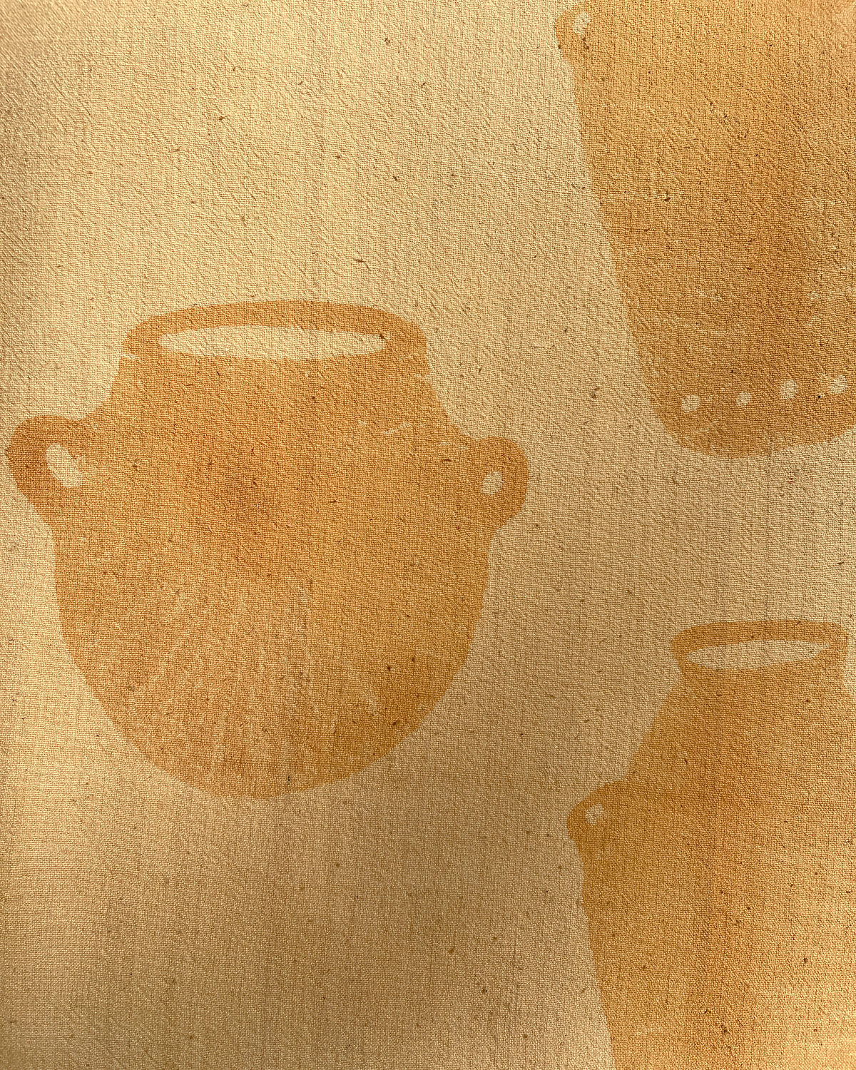 Textured beige fabric with brown abstract shapes resembling pots.