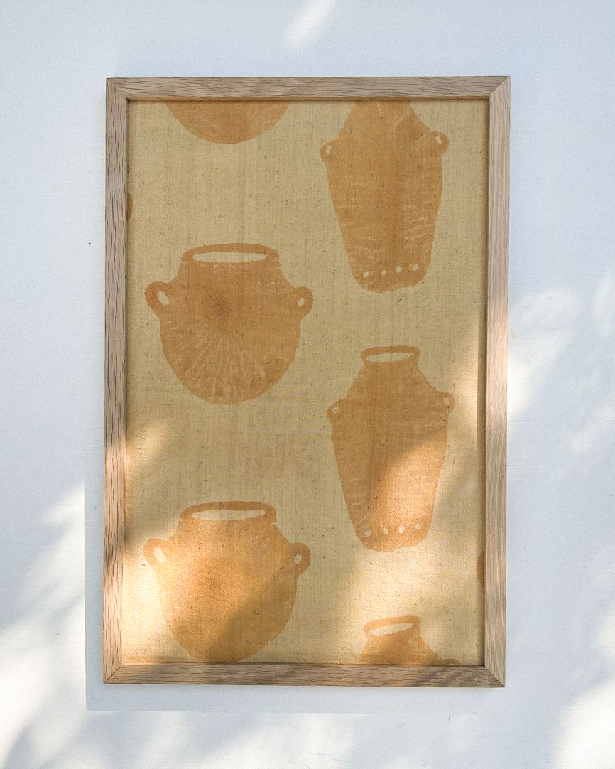 Framed artwork with brown pottery silhouettes on a textured beige background